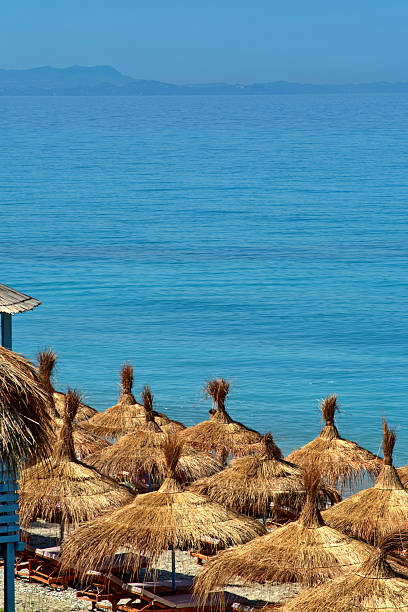 Straw umbrellas against the sea on Buneci beach