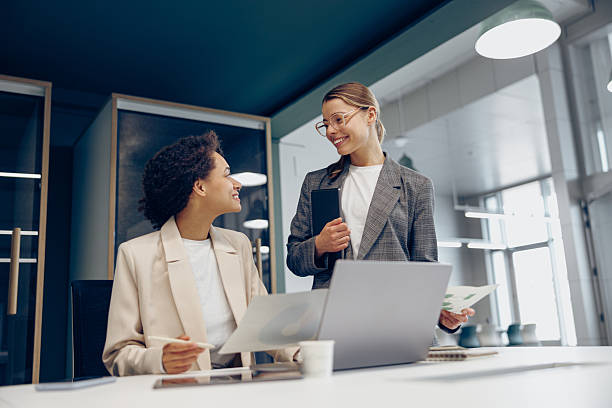 istock Two female colleagues discussing project before showing presentation to team leader in office 2229052654