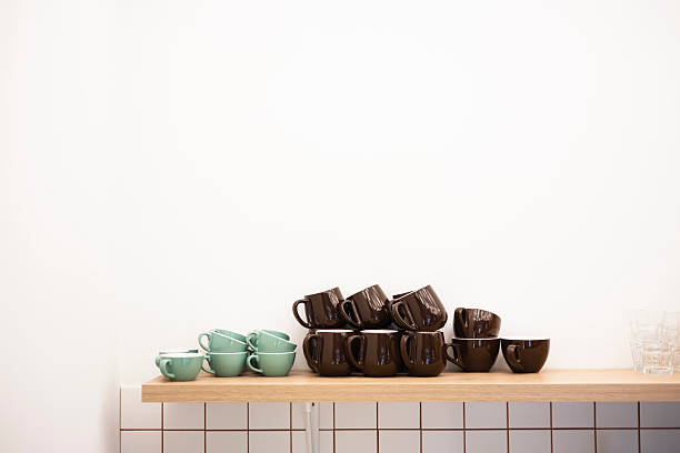 istock Stacked cappuccino coffee cups at kitchen or cafe shelf on white background. 2229054596