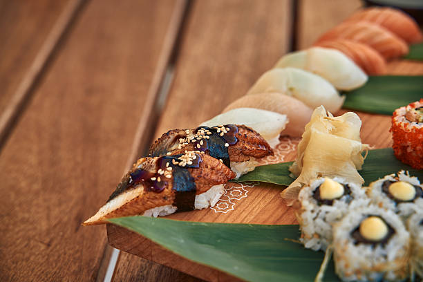 A Beautifully Arranged Selection of Sushi Varieties on a Wooden Platter, Showcasing Colorful Fish, Rice, and Fresh Ingredients