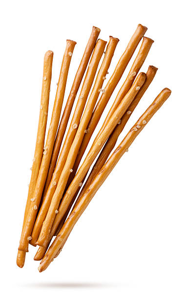 Salty cracker sticks flying close-up on a white. Isolated
