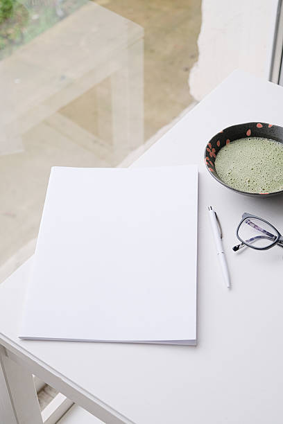 istock blank magazine mockup on coffee table with green matcha tea near window 2229057817