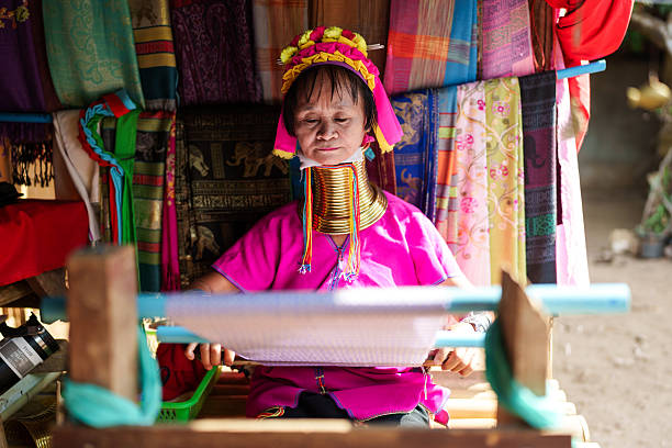 Pai, Chiang Mai, Thailand - May, 25, 2024: The Karen Long Neck Hill Tribe people, also know as the Kayan tribe people, are refugees from Burma, seeking better life in Thailand. They have a very distinct culture of wearing rings of brass around their necks.