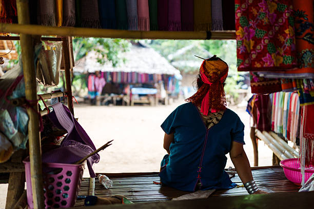 Pai, Chiang Mai, Thailand - May, 25, 2024: The Karen Long Neck Hill Tribe people, also know as the Kayan tribe people, are refugees from Burma, seeking better life in Thailand. They have a very distinct culture of wearing rings of brass around their necks.