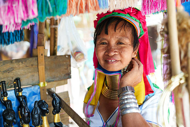Pai, Chiang Mai, Thailand - May, 25, 2024: The Karen Long Neck Hill Tribe people, also know as the Kayan tribe people, are refugees from Burma, seeking better life in Thailand. They have a very distinct culture of wearing rings of brass around their necks.