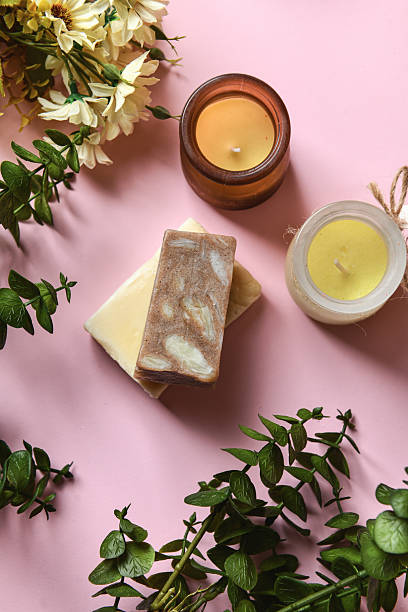 Colorful Organic Soap Bars Placed On Pink Surface With Flowers Framing Them