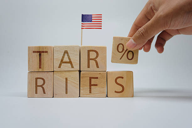 istock Wooden Blocks Displaying Tariffs Concept with Hand and American Flag 2229060790