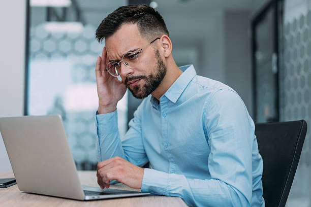 istock Stressed businessman having headache while working on laptop in the office. 2229062276
