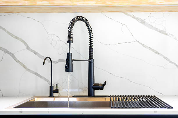 istock Running water stream. Black faucet. Marble wall 2229065698