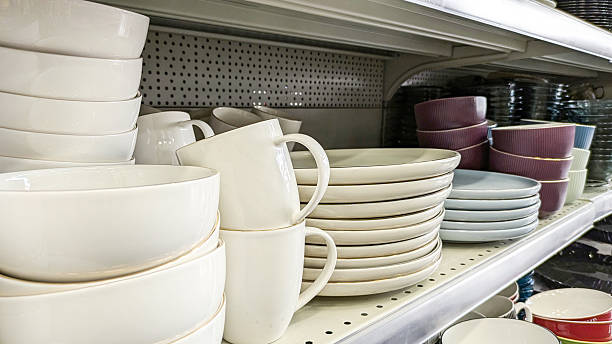 istock Close up of various ceramic dishware, including bowls, plates and mugs, neatly stacked on shelves in store. Ideal for concepts related to kitchen supplies, home decor and retail 2229067008