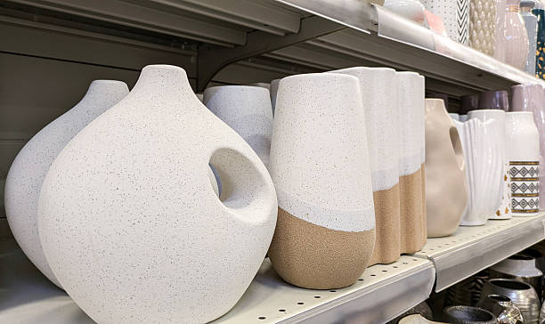 istock Row of various modern, minimalist ceramic vases with speckled texture and different shapes on store shelf. Concept of home decor, interior design and modern art 2229067031