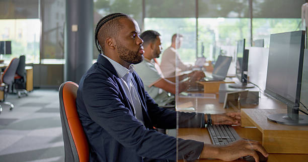 istock Professional Black Businessman In Navy Suit Working At Modern Office Computer Workstation 2229068907