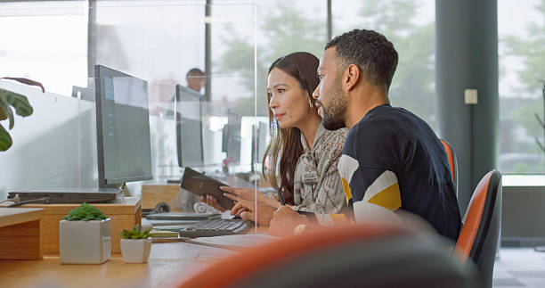 istock Diverse Business Executives Collaborating in Modern Open Space Office with Natural Lighting 2229068918