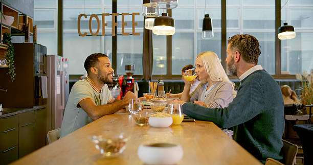 istock Diverse Business Colleagues Sharing Drinks And Conversation At Modern Coffee Shop Counter 2229068962