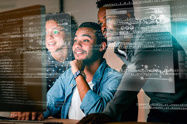 Team Collaborating on Programming With Digital Interface and Data Visualization Overlay stock photo