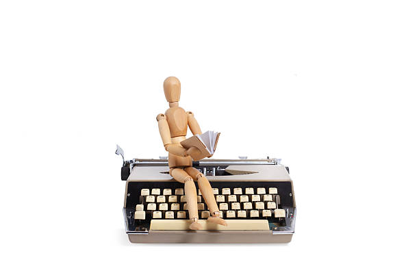 Typewriter on wooden desk with idyllic sky behind it.