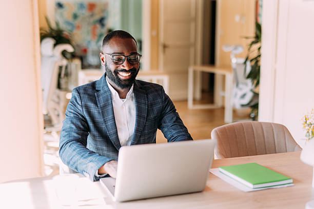 istock Successful businessman in modern office working on laptop. 2229073686