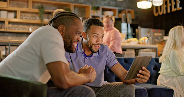 istock Diverse Business Professionals Engaged with Digital Tablet in Modern Office Lounge 2229073950