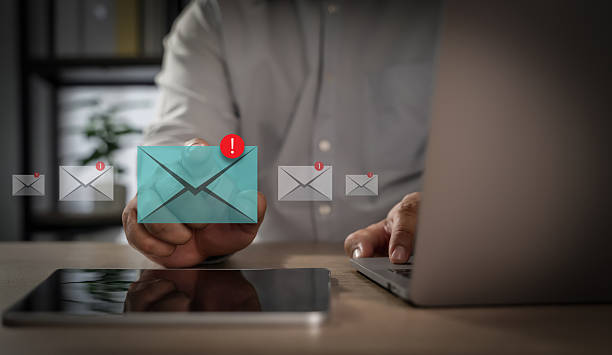 istock Mail Communication Connection Person managing email notifications digital devices, with alert icons indicating new messages and urgent updates 2229074173