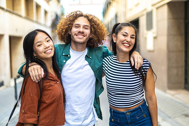 istock Happy multi ethnic friends embracing in the city 2229076025