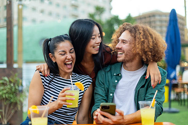 istock Happy friends laughing and having fun outdoors at a cafe 2229076106
