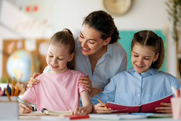 istock Happy kids and teacher at school 2229077280