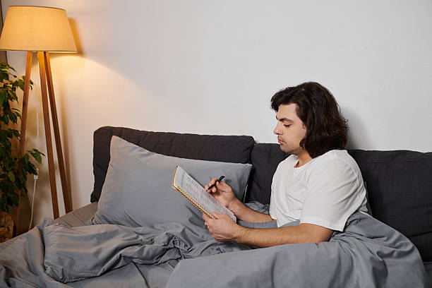 istock Engaging in self reflection and creativity, a young man cultivates vitality at home 2229078315
