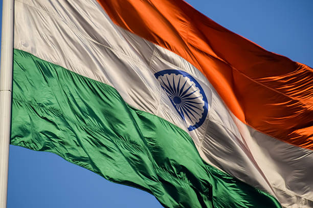 istock India flag flying high at Connaught Place with pride with plain white background, India flag fluttering, Indian Flag on Independence Day and Republic Day of India, tilt up shot, Har Ghar Tiranga 2229079569