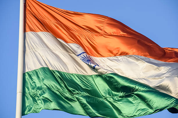 istock India flag flying high at Connaught Place with pride with plain white background, India flag fluttering, Indian Flag on Independence Day and Republic Day of India, tilt up shot, Har Ghar Tiranga 2229079602