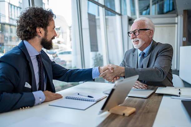 istock Businessmen shaking hands during a corporate meeting 2229080912