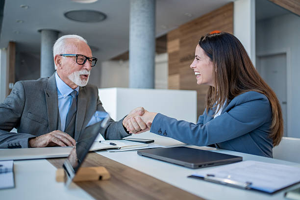 istock Businesspeople shaking hands after successful meeting in office 2229080932