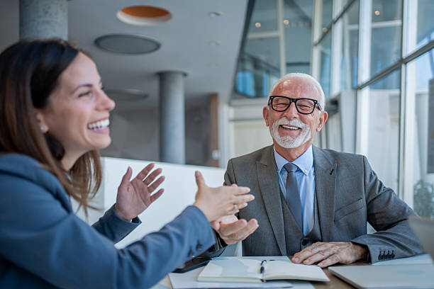 istock Business people having a conversation and smiling at the office 2229080952