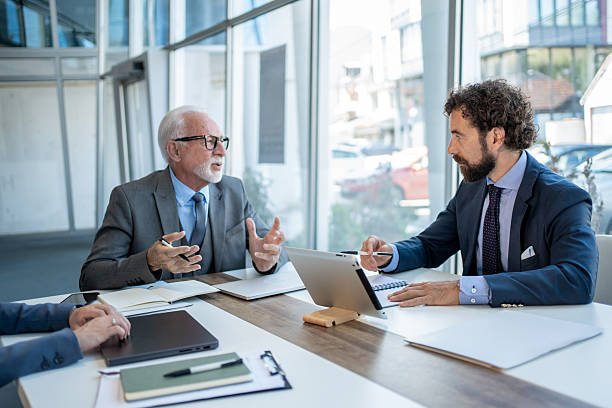 istock Businessmen discussing work in modern office during meeting 2229080987