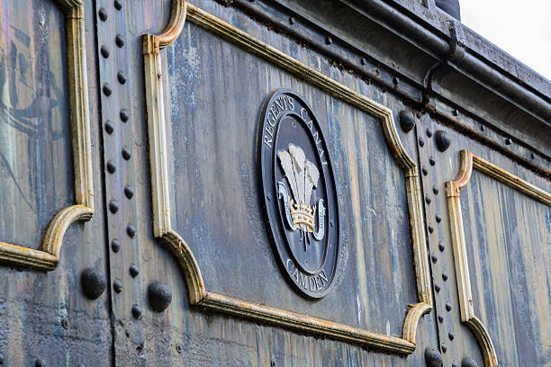 Close-up of a weathered industrial panel featuring a detailed emblem associated with Regent’s Canal in Camden, London. The aged texture and design convey a sense of history and heritage.