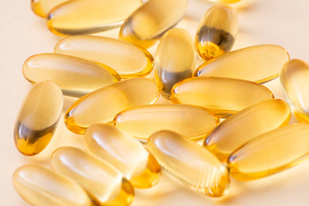 istock Yellow Softgel Capsules on Beige Background 2229082008