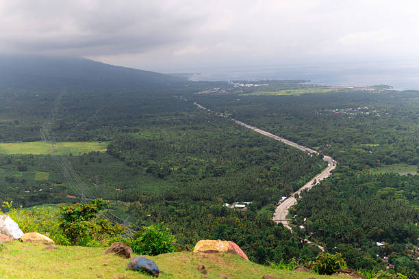 A sweeping view from Lantawan Mountain Resort of the Davao region’s lush farmlands, tree-lined highways, and expansive forest canopy beneath a moody sky, capturing the rural sprawl from elevation.