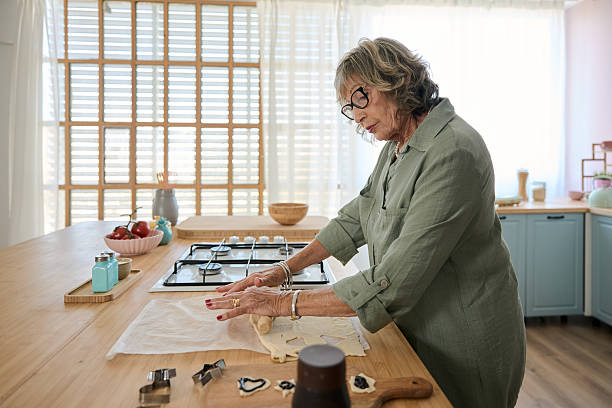 istock Senior woman making cookies in a modern kitchen 2229087861