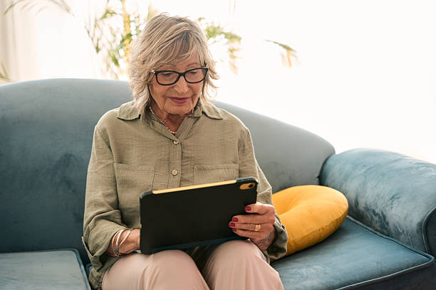 istock Senior adult woman using digital tablet at home 2229087905