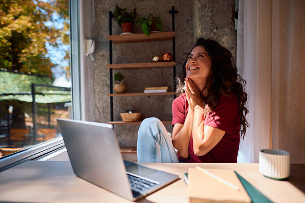 istock Happy freelancer woman celebrating success working from home 2229088399