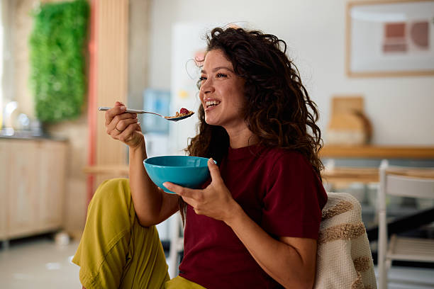 Young Woman Enjoying a Healthy Breakfast at Home