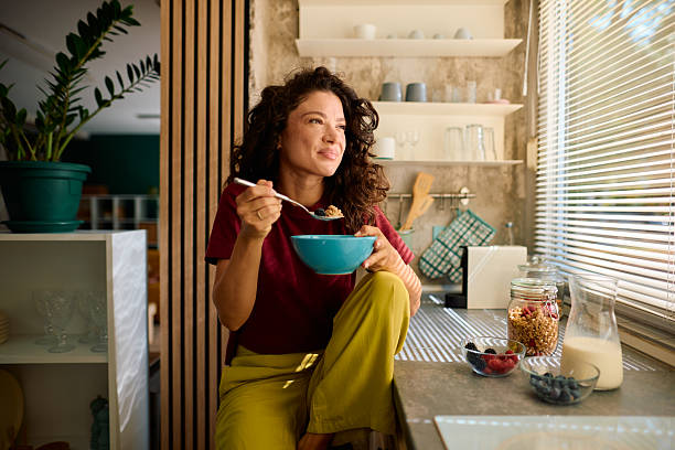 istock Young woman enjoying healthy breakfast in modern kitchen 2229088689