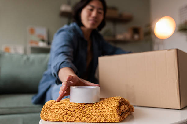 istock Man Preparing to Close Cardboard Box with Tape 2229088812