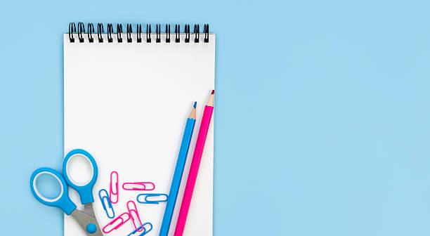 istock Notebook, pencils, scissors and paperclips on a blue background. Back to school. Flatlay. Top view. Copy space. 2229090770