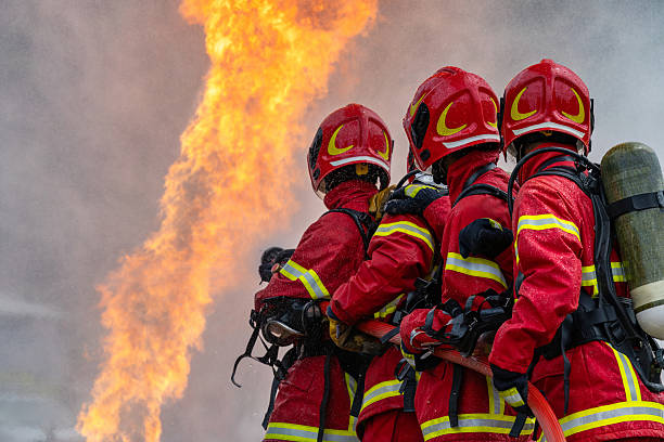 Rescue Training . Firefighter Concept. Fireman using water and extinguisher to fighting with fire flame. firefighters fighting a fire with a hose and water during a firefighting training exercise