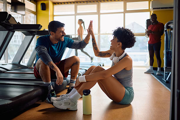 istock Happy athletic couple giving high-five after successful workout in a gym. 2229097246