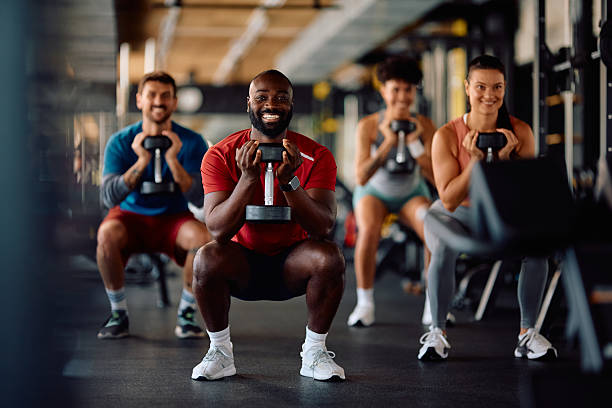 istock Multiracial athletes exercising with hand weights during gym workout. 2229097500