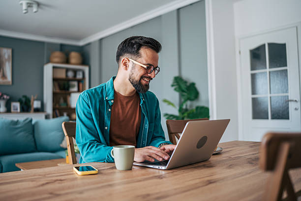 istock Freelancer working from home on laptop and smiling 2229097843