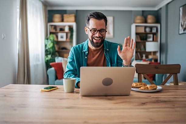 istock Freelancer waving at laptop during video conference call from home 2229098260
