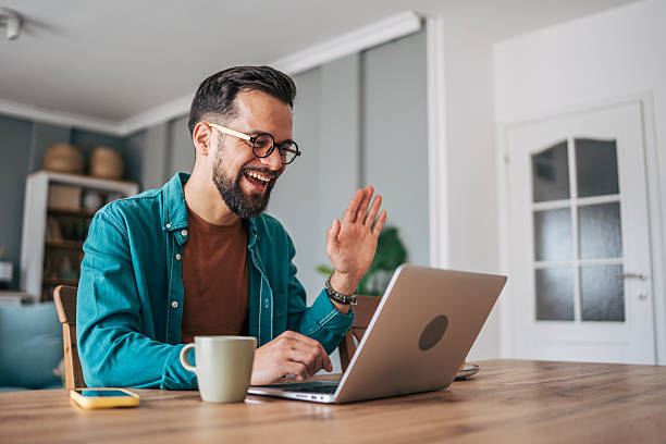 istock Young man working from home having a video call on his laptop 2229098262
