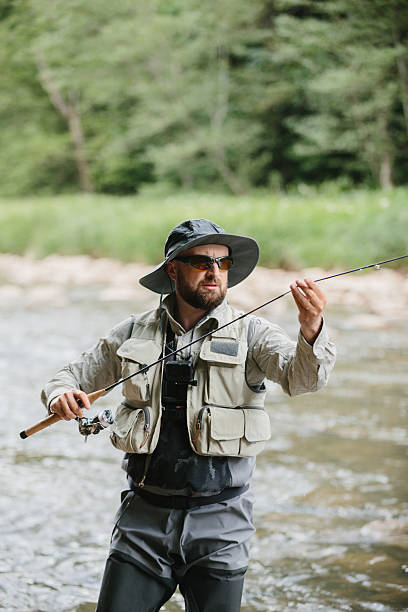 istock Fisherman catching trout in river, enjoying peaceful nature 2229098609